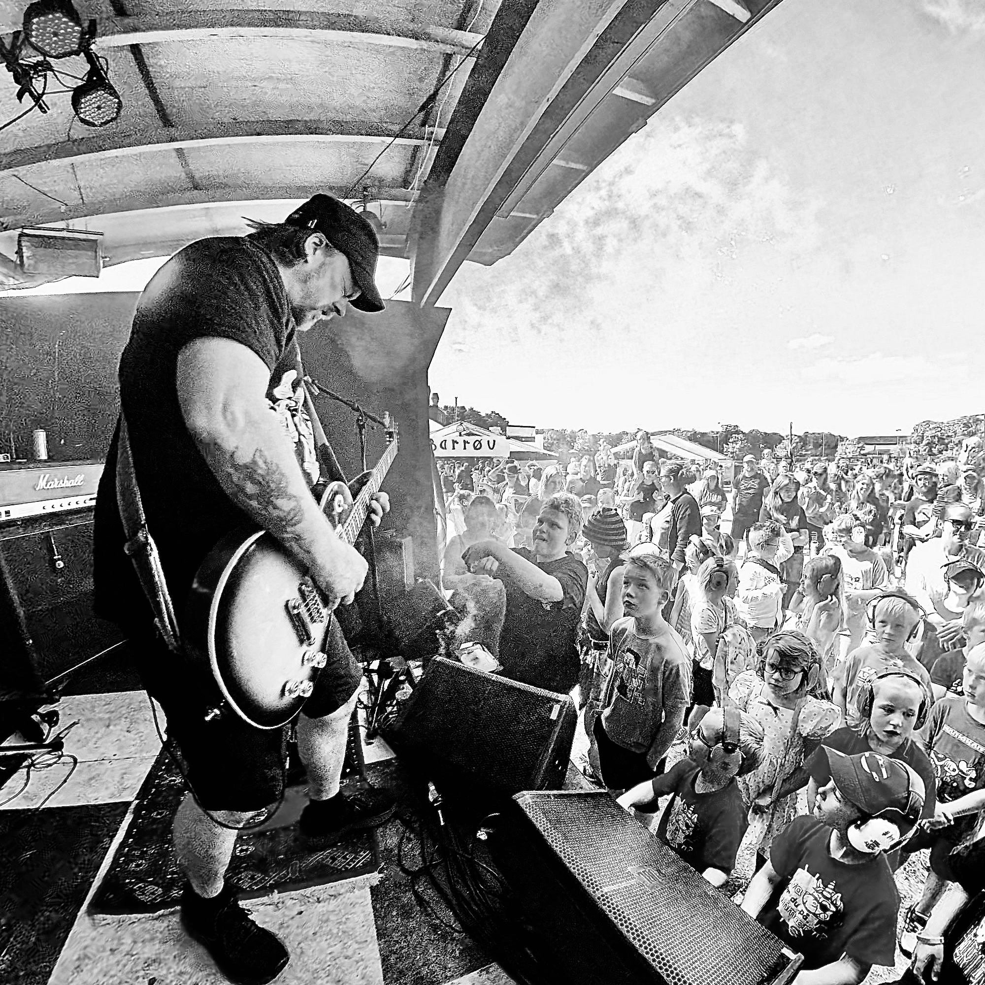 Gitaristen i TRASS spiller mot et fullt publikum av barn på festival